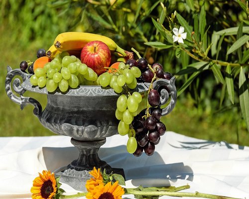 Person holding a healthy fruit bowl